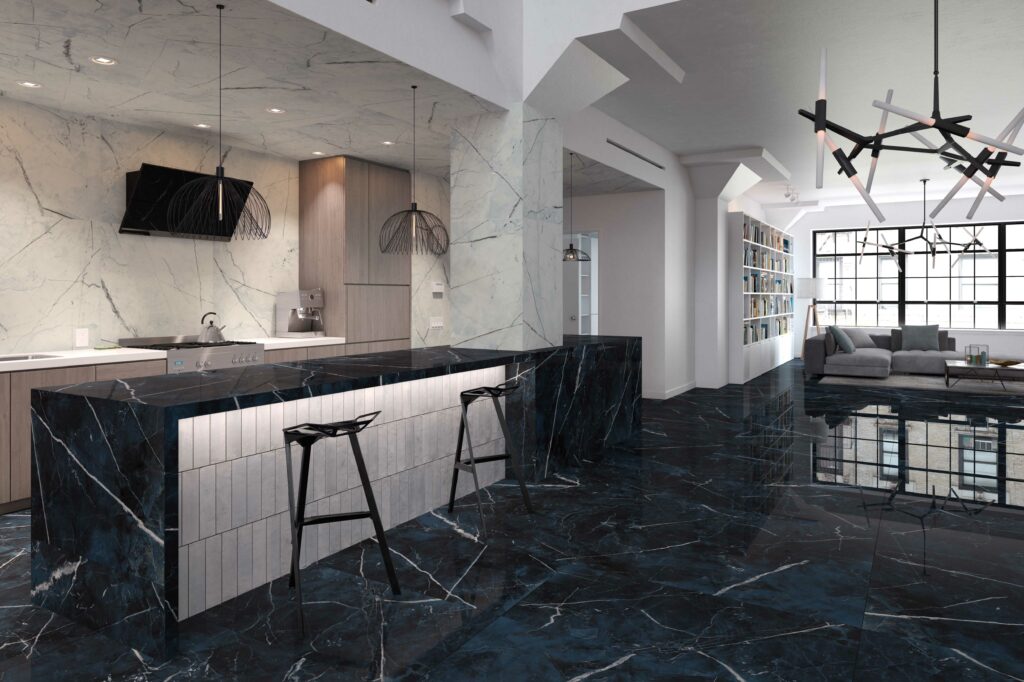Cocina integrada en salón con encimera de mármol porcelánico oscuro y revestimiento de mármol porcelánico blanco. Pavimento de mármol porcelánico oscuro.